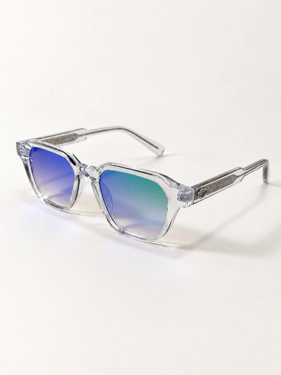 Auracle AUR-001 C2. Three-quarter view of clear square sunglasses with blue, lilac and teal reflective lenses and textured metallic temples.